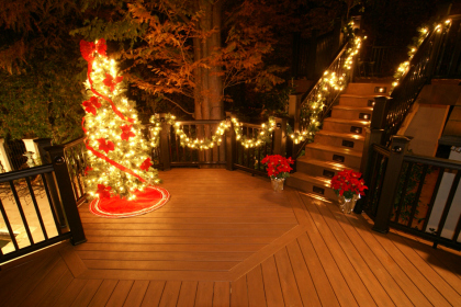 Christmas tree lit up on a deck